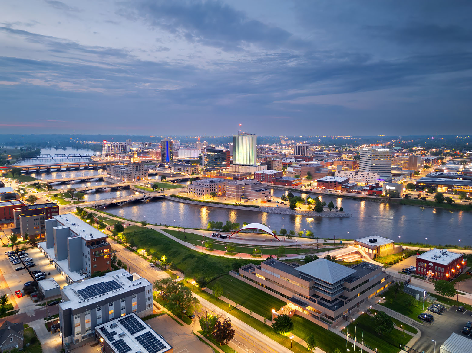 Cedar Rapids, Iowa, USA cityscape on the Cedar River at dusk.